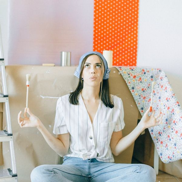 Person in a balancing yoga pose against a clean background.